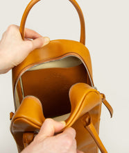 Load image into Gallery viewer, GUT OGGAU x SAGAN Vienna bag white I  white I inside view I showing open inside leather pocket with embossing "Gut Oggau x SAGAN Vienna" I white background